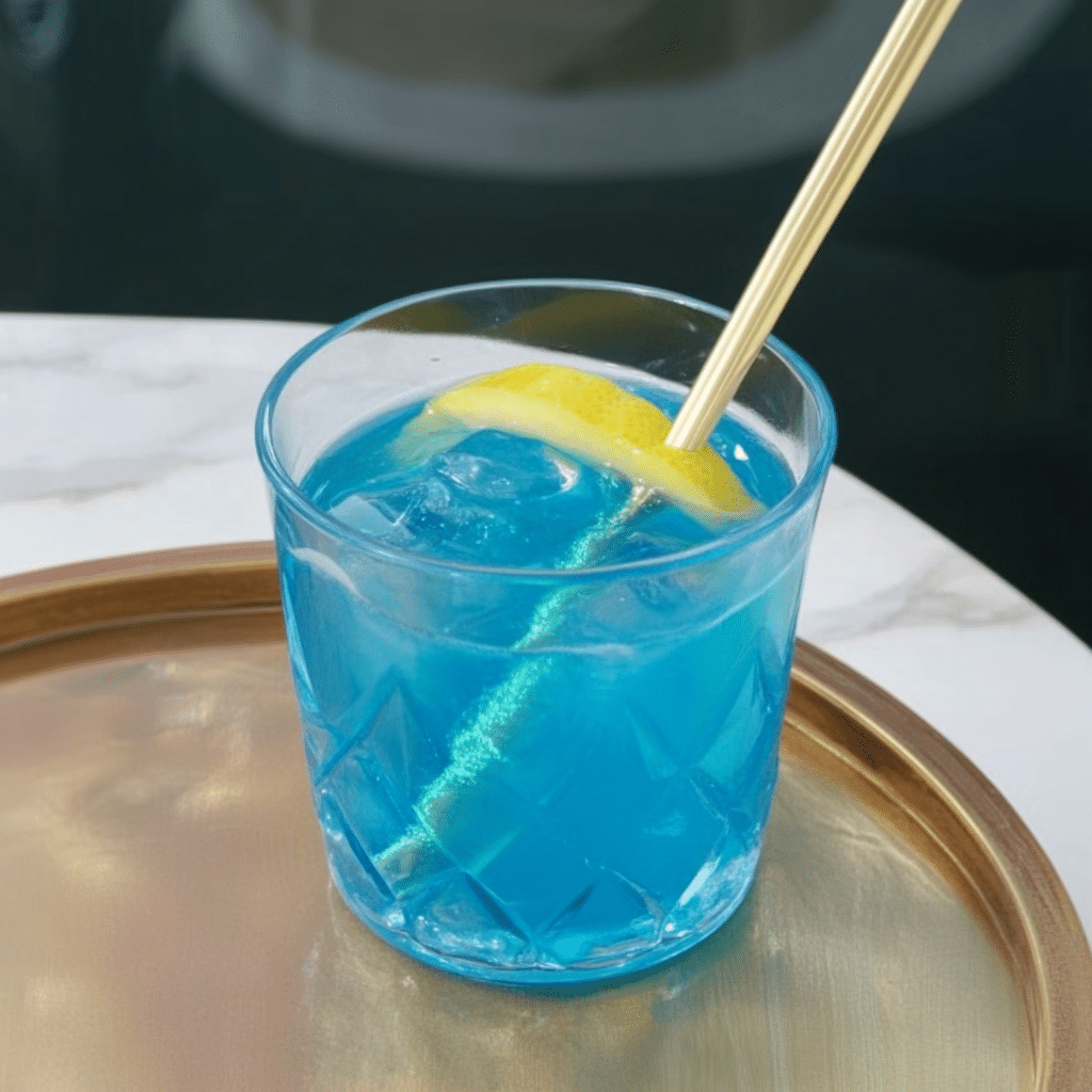 Blue Salt Trick – A detox water glass with visible blue salt crystals, cucumber slices, and a lemon wedge.